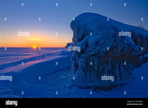 Ice on shore of lake winnipeg at sunrise hi-res stock photography and