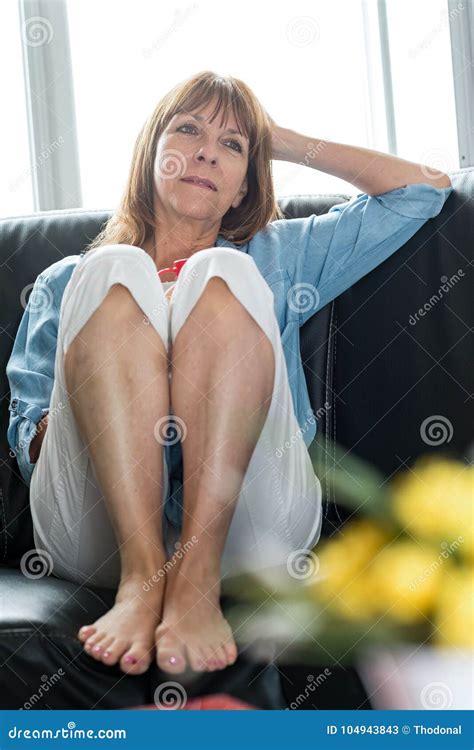 Pensive Mature Woman Sitting On Sofa Stock Image Image Of Woman Sitting