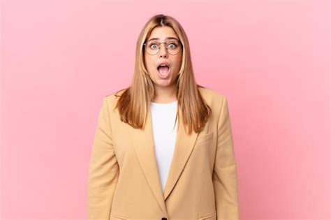 Premium Photo Curvy Pretty Blonde Woman Looking Very Shocked Or Surprised