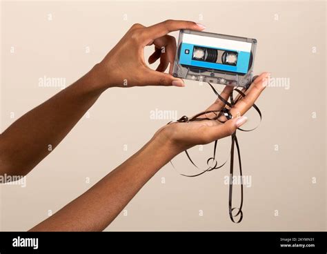 Crop Hands Of Black Woman Demonstrating Tape Cassette With Tape Out