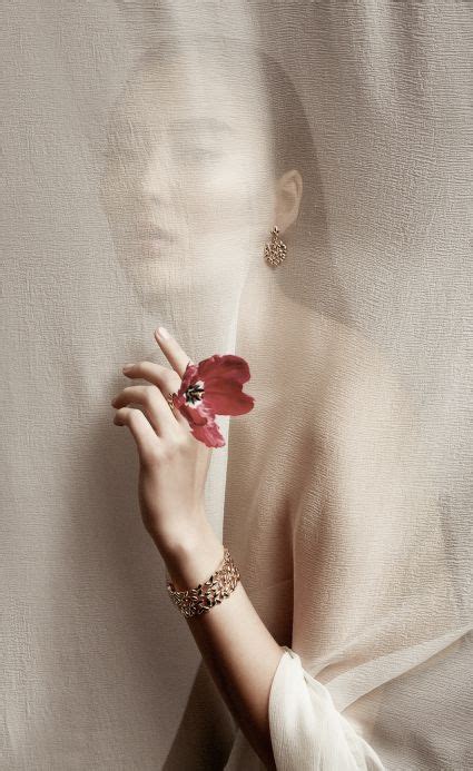 A Woman With Bracelets And A Flower In Her Hand