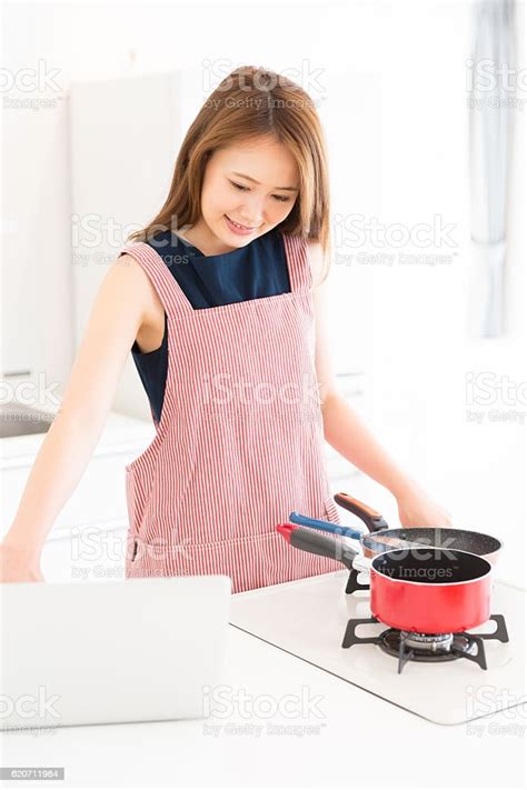 Japanese Woman Cooking In Kitchen Stock Photo Download Image Now