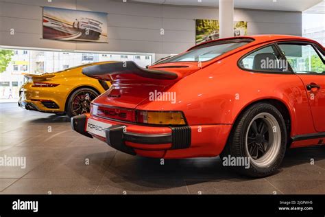 A Picture Of A Red Porsche 911 Carrera 3 0 Next To An Orange Porsche 911 Turbo S Inside A