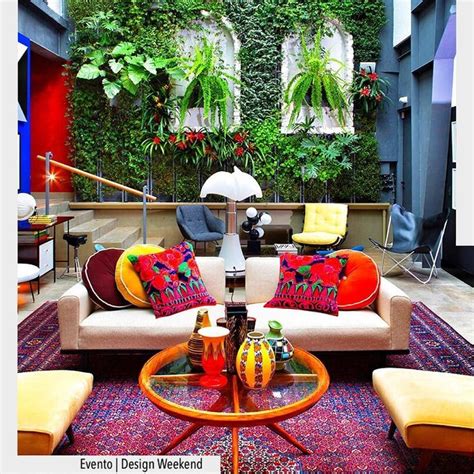 A Living Room Filled With Lots Of Furniture And Plants On The Wall Next