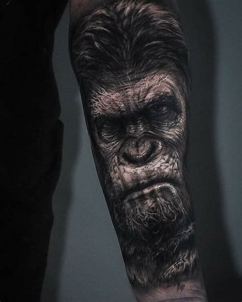 A Man S Arm With A Gorilla Face Tattooed On The Upper Part Of His Arm