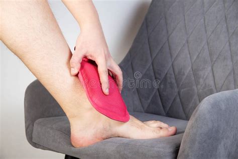 Treatment Of Pain And Inflammation Of The Ankle Joint With A Heating Pad With Hot Water Removal