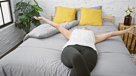 Beautiful Middle Age Blonde Woman Cozying Up In The Comfort Of Her Bedroom Stretching Her Arms