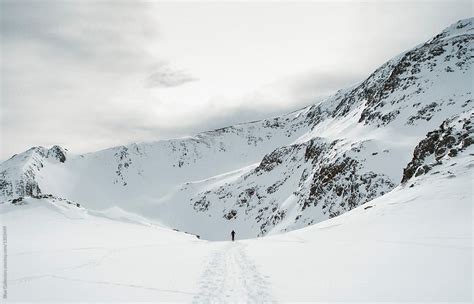 "Skier Walking Through Snow Valley" by Stocksy Contributor "Blue Collectors" - Stocksy