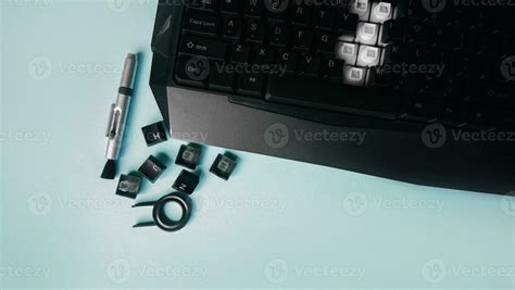 Keyboard, keys, brushes and key for replacing keys on a blue background