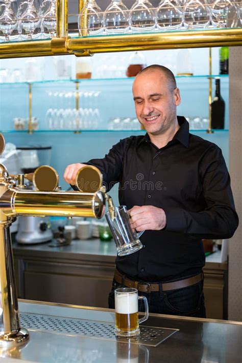 Bar Tender Filling Beer From Bar Pump Stock Image Image Of Smiling