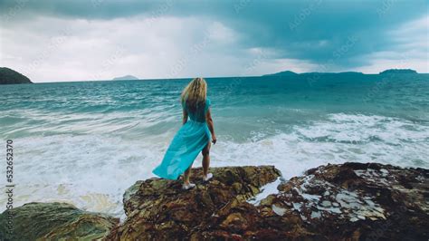 Sexy Hot Woman Meditates Relaxes On A Rock Reef Hill In Stormy Morning Rain Cloudy Sea Girl In