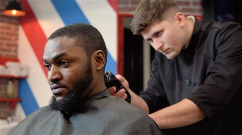 A young man gets a haircut from a top master of men's haircut. Man in barbershop 40756679 Stock ...