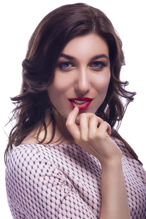 Portrait Of Caucasian Brunette Woman Posing With Her Finger Touching Red Lips With Passionate