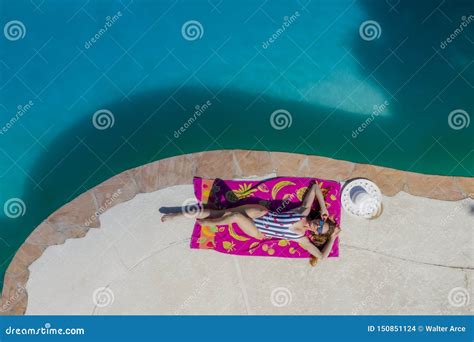 A Lovely Brunette Swimsuit Model Enjoys Her Holiday At The Pool Stock Photo Image Of