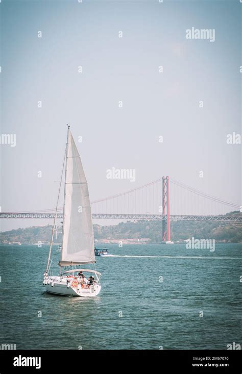 A Sailboat On The Rio Tejo Tagus River In Lisbon Portugal The Ponte