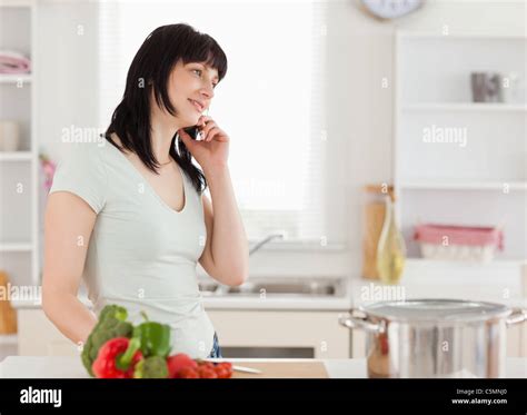 Attractive Brunette Woman On The Phone While Standing Stock Photo Alamy