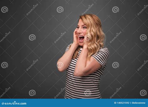 Emotional Blonde Screams Frightened Woman Screaming Straining Standing On A Gray Background
