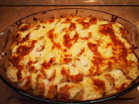 A Cheesy Pizza In A Glass Dish On A Table