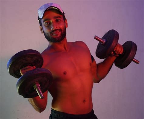 Premium Photo Man Lifting Weights In Neon Light