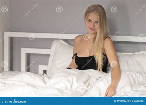 Beautiful Flirty Blonde On Bed With White Sheets Pretty People On Isolation Stock Photo Image