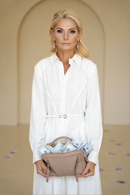 Free Photo Portrait Of Middle Aged Blonde Rich Woman With Banknotes In Purse