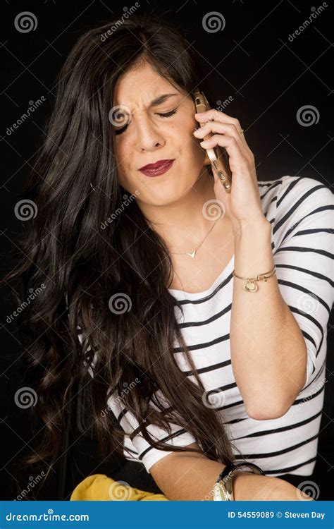 Pretty Brunette Talking On Her Cell Phone With Her Eyes Closed Stock