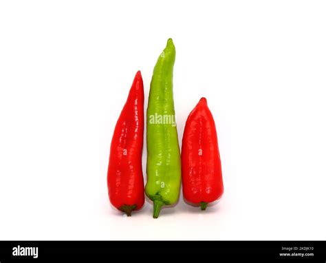 Three chili peppers of red and green color on a light background