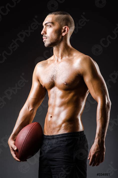 muscular football player  ball stock photo  crushpixel