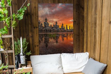 Tuinposter Boeddha Beelden Zonsondergang Water Boeddhisme