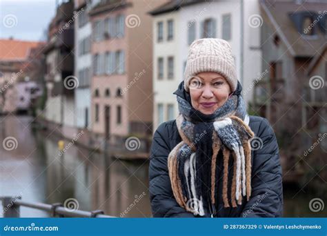 Close Up Portrait Mature Woman At The Amazing Traditional Colorful Houses In La Petite France