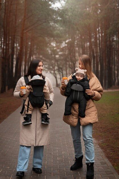 Free Photo Full Shot Women Holding Babies In Carriers