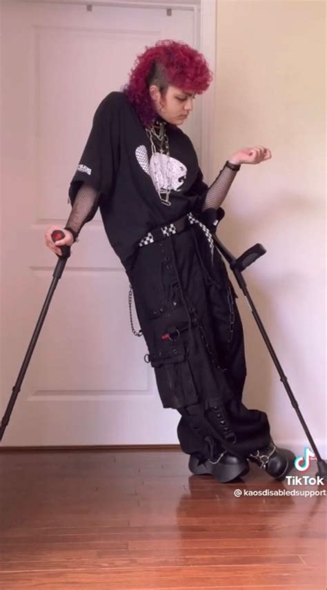 A Woman With Red Hair Is Standing On Crutches