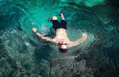 Premium Photo Shirtless Man Swimming In Sea