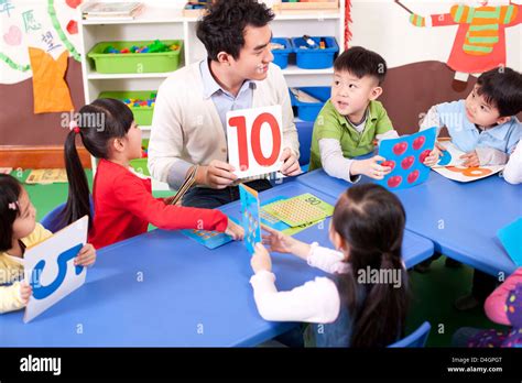 Kindergarten teacher teaching children maths Stock Photo - Alamy