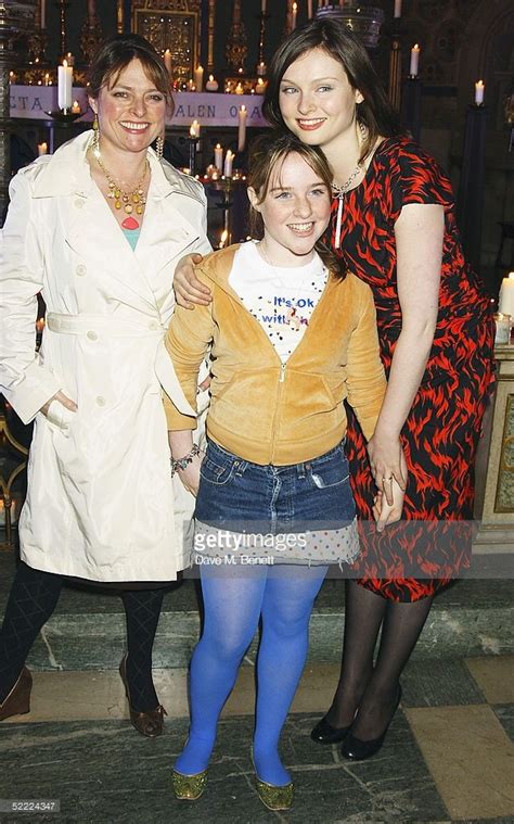 Three Women Standing Next To Each Other In Front Of Candles