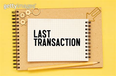 Closeup On Businessman Holding A Card With Text LAST TRANSACTION