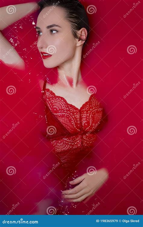 Portrait Of A Beautiful Brunette In Red Lingerie In Red Water Horror Films Photoshoot In The