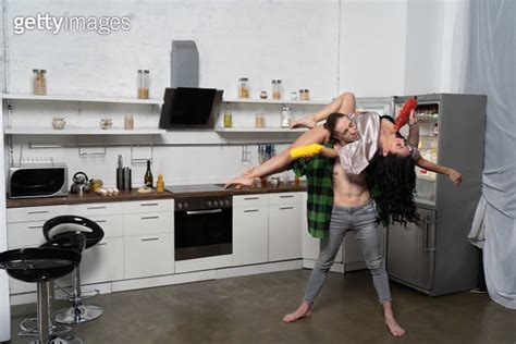 nude woman flirting in the kitchen with man concept of creative relationship 게티이미지뱅크