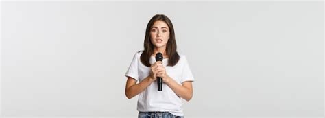 Free Photo Shy Cute Brunette Girl Scared Of Singing In Public Standing With Microphone And