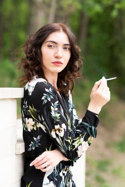Free Photo Brunette Girl Looking Away And Smoking