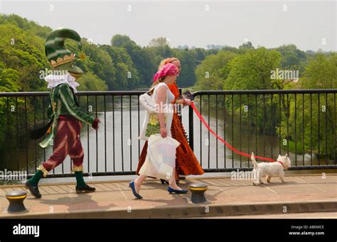 Performers from Giffords Circus one in green frog costume on street Stock Photo: 4158669 - Alamy