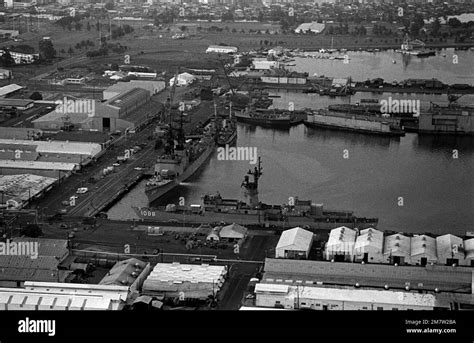 An Aerial View Of The Us Naval Ship Repair Facility Moored At The Facility Are The Spruance