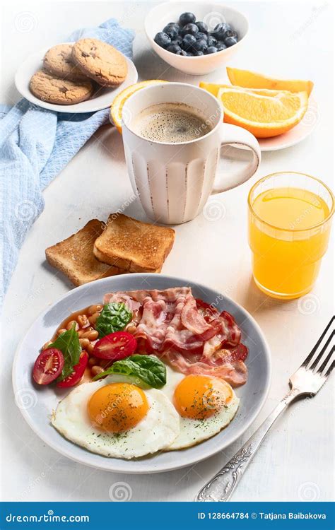 Breakfast With Fried Eggs Bacon Orange Juice Yogurt And Toast Stock