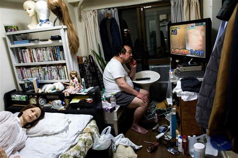 Senji Nakajima Speaks On His Mobile Phone As His Silicone Sex Doll Saori Lies In Bed At His