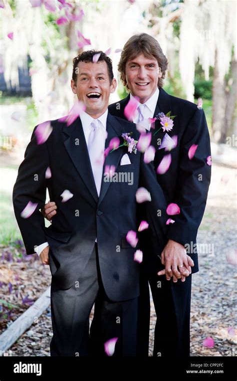 Gay Wedding Couple Being Showered With Rose Petals Stock Photo Alamy