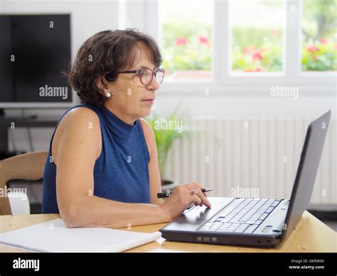 A Beautiful Mature Woman With Her Laptop In The House Stock Photo Alamy