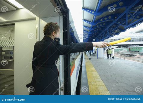 Female Train Conductor Signaling Departure of the Passenger Train ...