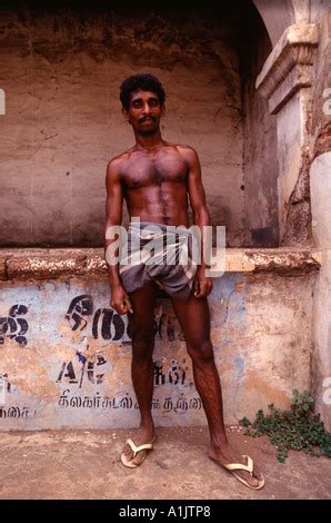 Naked Indian Strong Man With Traditional Native American Make Up And Headdress Looking At The