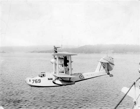 A Supermarine Built Walrus Seaplane Suspended From A Crane City