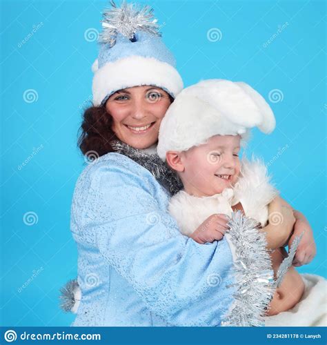Young Woman in a Snow Maiden Costume with a Baby in a Costume of Rabbit
